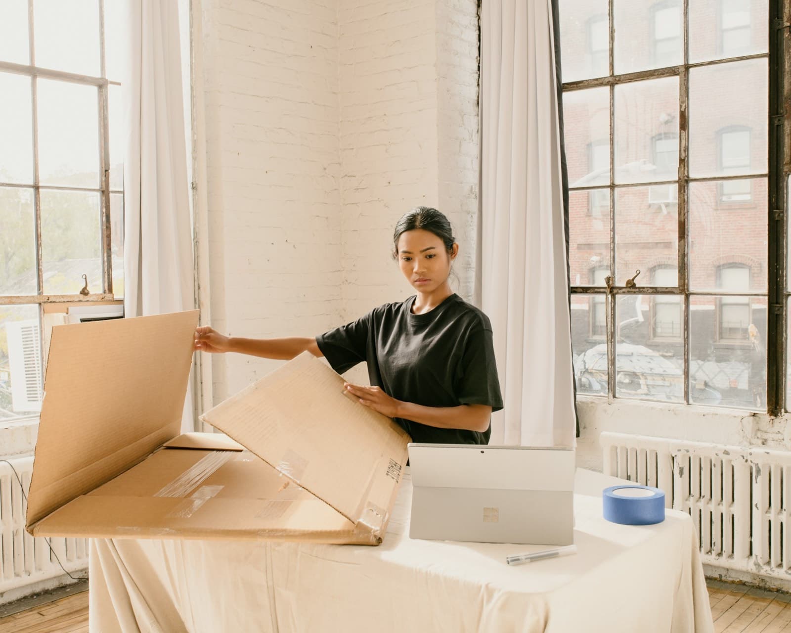 A business owner packing an online order at her desk