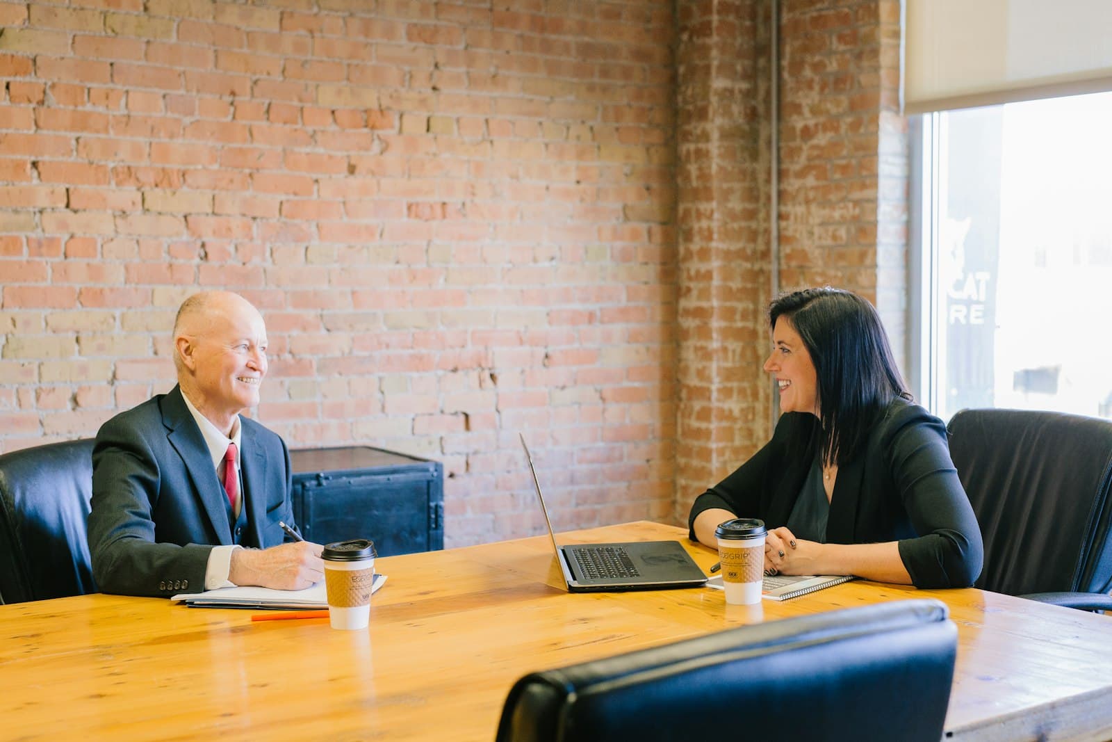 A lawyer meeting with a client in a bright office