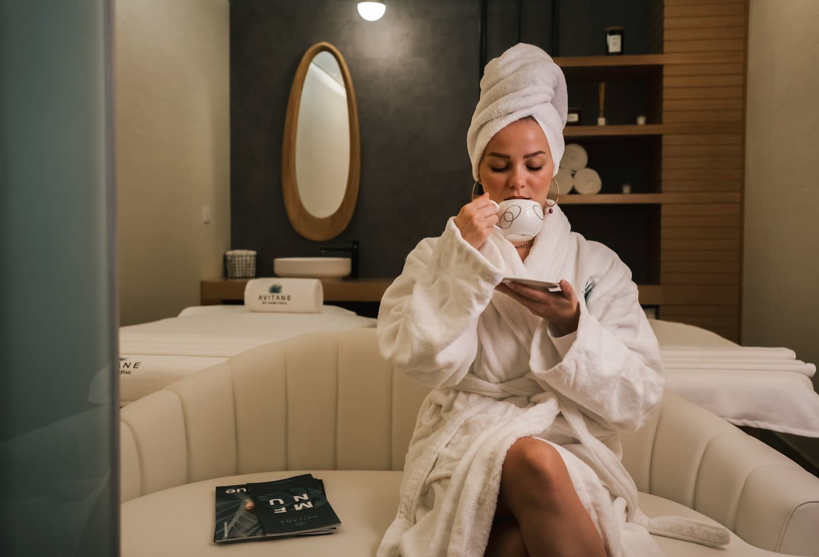 A client relaxing in a robe in a spa lounge