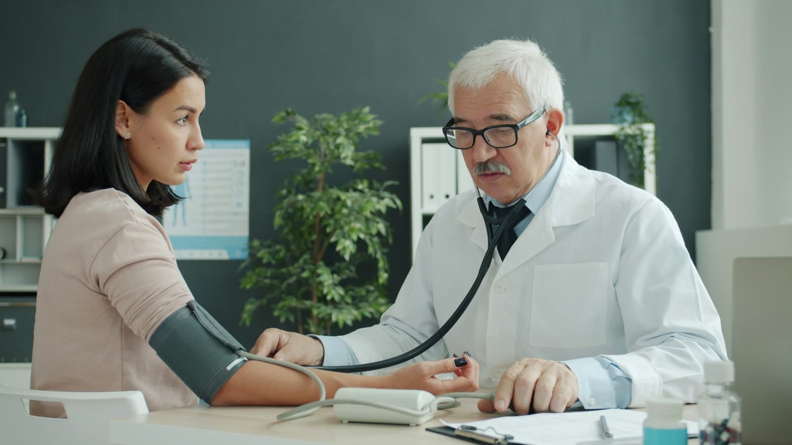 A doctor checking a patient's blood pressure
