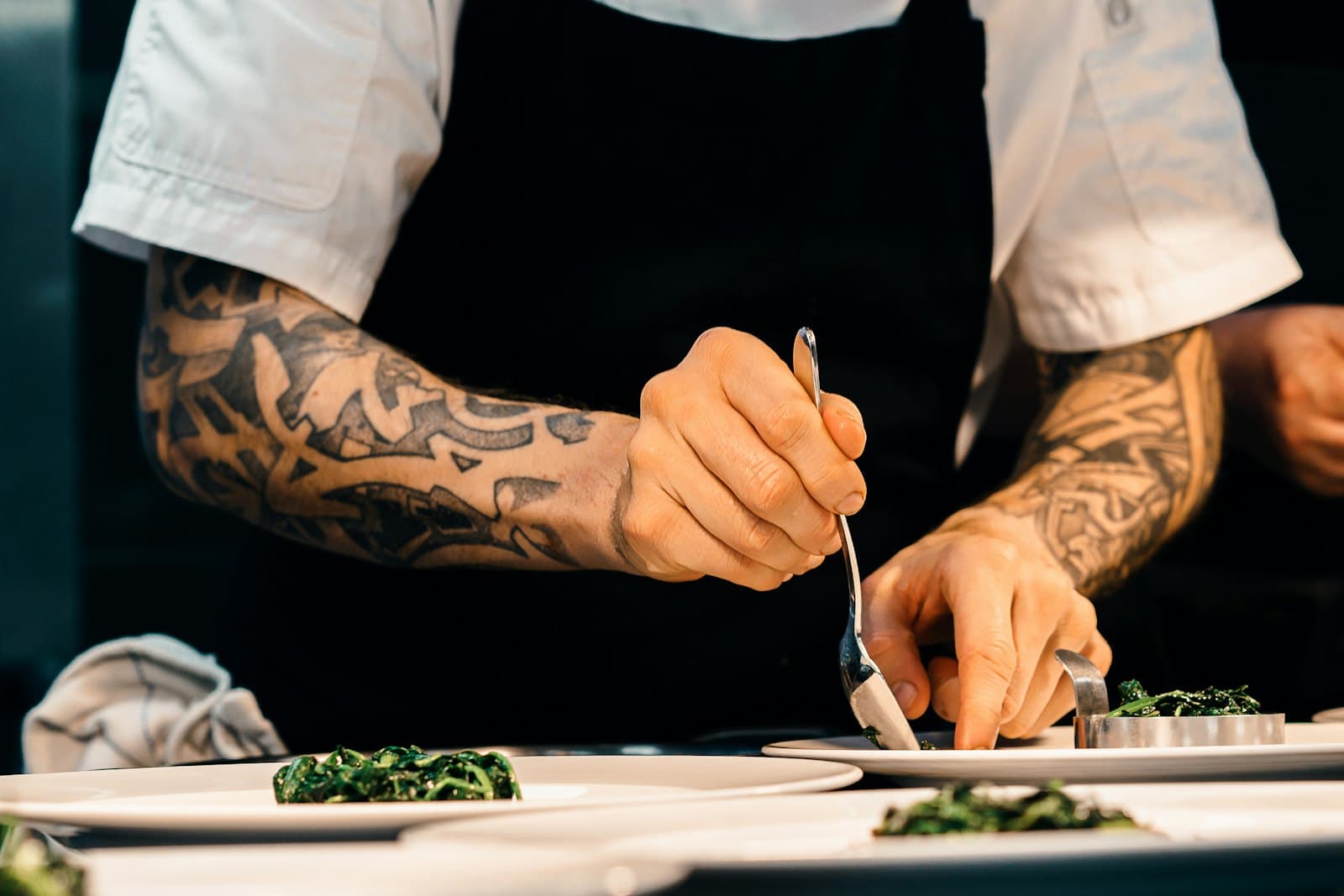 A chef carefully plating a dish